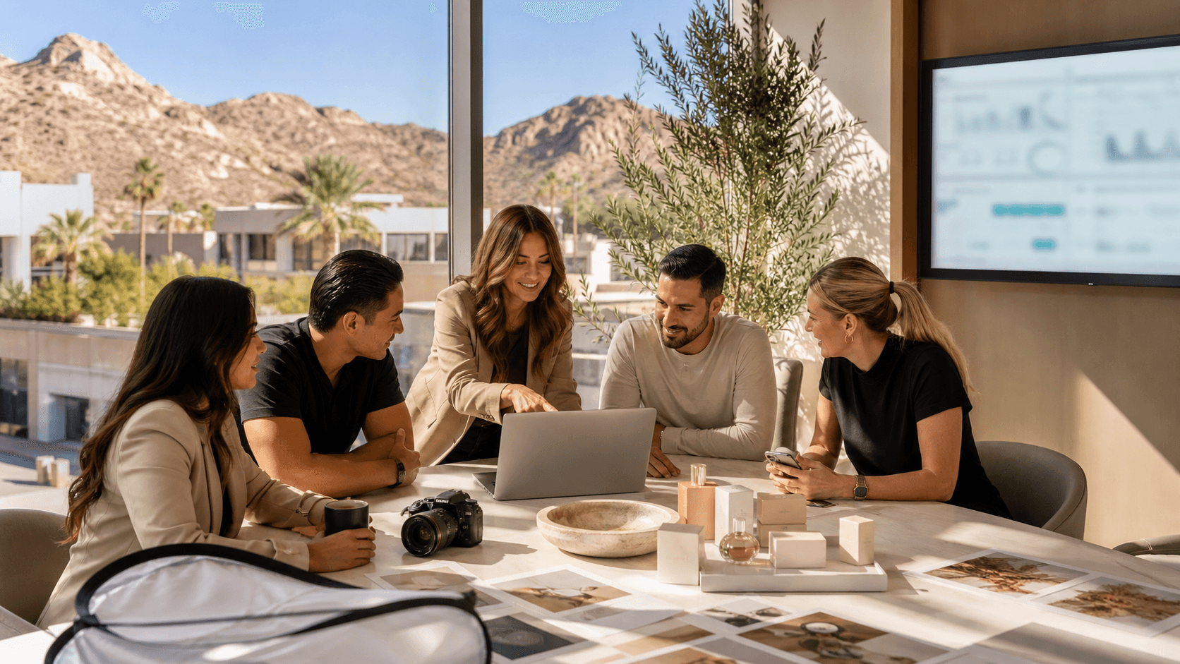 Modern city skyline at sunset with desert mountains, warm orange sky, and a laptop showing analytics in foreground